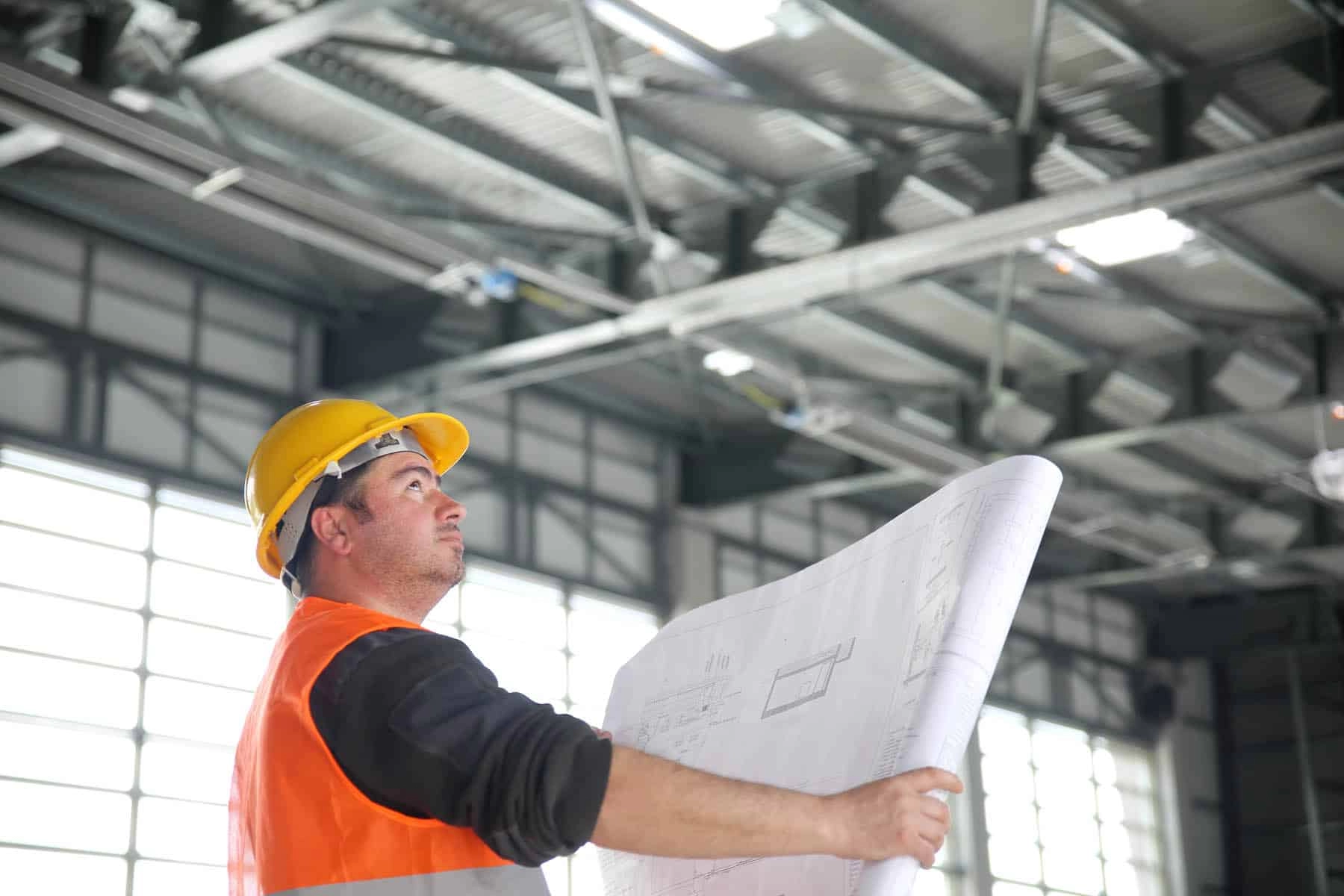 Construction worker reading blueprints