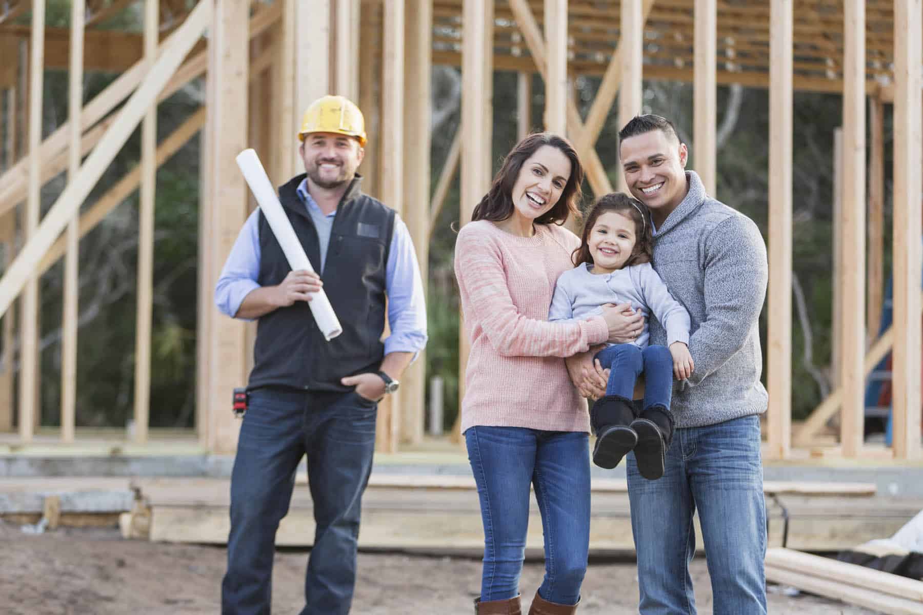 family standing in front of house under construction